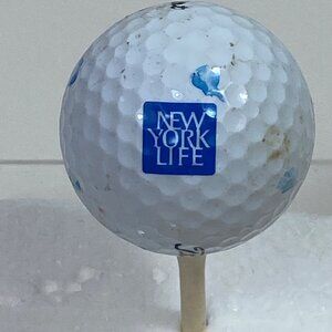 Title: Used Titleist 2 Golf Ball With New York Life Logo - Scuffs & Stains